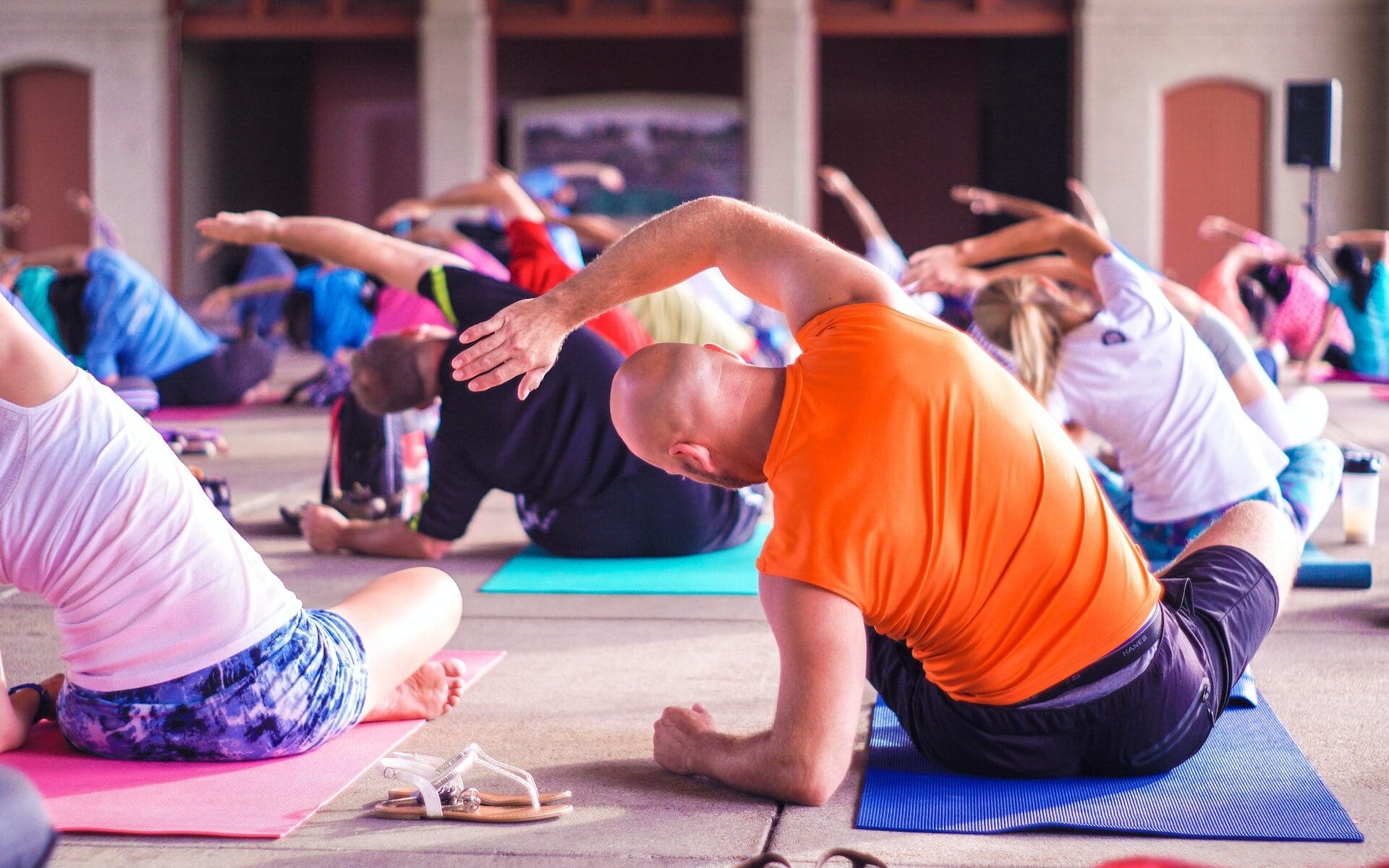 man stretching in corporate yoga class