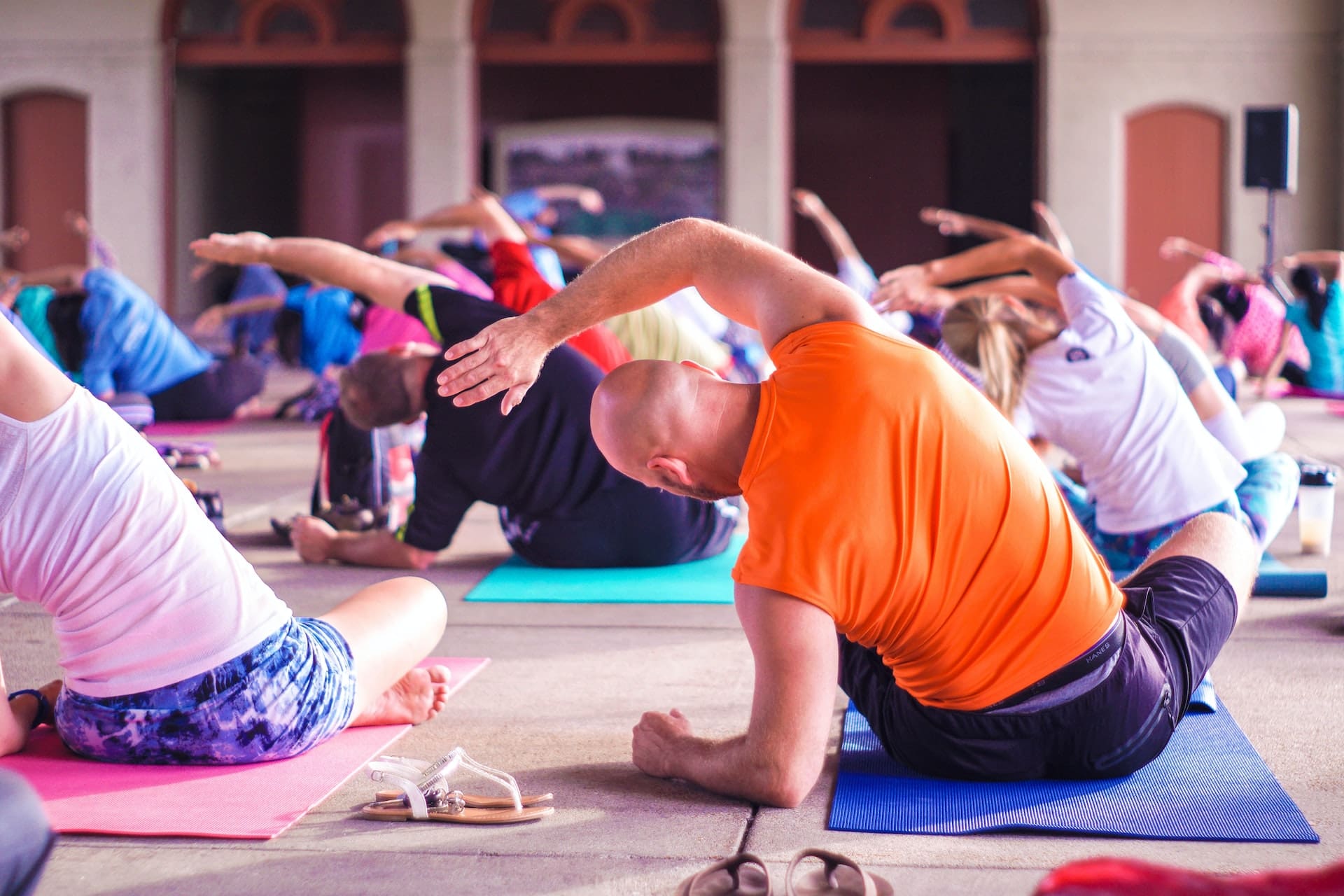 man stretching in corporate yoga class